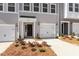 Close up of new townhomes with driveways and landscaping at 107 Central Townes Way # 298, Raleigh, NC 27603
