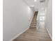 Entry way with wood floors and carpeted stairs at 107 Central Townes Way # 298, Raleigh, NC 27603
