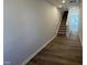 Hallway features luxury vinyl flooring and carpeted stairs at 107 Central Townes Way # 298, Raleigh, NC 27603
