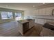 Modern kitchen with granite island and stainless dishwasher at 107 Central Townes Way # 298, Raleigh, NC 27603