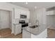 Bright kitchen features stainless appliances, granite counters and a kitchen island at 107 Central Townes Way # 298, Raleigh, NC 27603