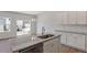 New kitchen with stainless dishwasher, granite counters and white cabinets at 107 Central Townes Way # 298, Raleigh, NC 27603