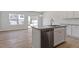 Open floor plan with kitchen island and stainless steel appliances at 107 Central Townes Way # 298, Raleigh, NC 27603