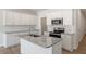 Kitchen island with granite countertops and stainless steel appliances at 107 Central Townes Way # 298, Raleigh, NC 27603