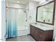 Modern bathroom with marble vanity and walk-in shower at 110 N Corcoran St # 2104, Durham, NC 27701