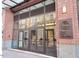 Modern building entrance with glass doors and One City Center signage at 110 N Corcoran St # 2104, Durham, NC 27701