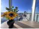 Dining area with a sunflower centerpiece and a stunning city view at 110 N Corcoran St # 2104, Durham, NC 27701