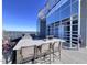 Rooftop outdoor kitchen with built-in grill, granite counters, and seating for multiple people at 110 N Corcoran St # 2104, Durham, NC 27701