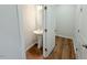 Well-lit powder room featuring a pedestal sink and wood flooring at 111 Central Townes Way # 299, Raleigh, NC 27603