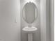 Bathroom pedestal sink and mirror at 111 Central Townes Way # 299, Raleigh, NC 27603