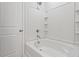 White bathtub with tiled walls and shower head at 111 Central Townes Way # 299, Raleigh, NC 27603