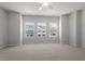 Bright bedroom with neutral carpet, ceiling fan and plenty of natural light from the three windows at 111 Central Townes Way # 299, Raleigh, NC 27603