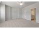 Bright bedroom with neutral carpet, ceiling fan, and bathroom doorway at 111 Central Townes Way # 299, Raleigh, NC 27603