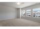Bright bedroom with neutral carpet, ceiling fan and plenty of natural light from the three windows at 111 Central Townes Way # 299, Raleigh, NC 27603