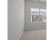 Small bedroom with neutral carpet and a view of another house at 111 Central Townes Way # 299, Raleigh, NC 27603