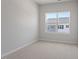Small bedroom with neutral carpet and a view of another house at 111 Central Townes Way # 299, Raleigh, NC 27603