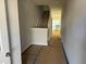 Bright entryway featuring staircase leading to the upper level, with neutral paint, and a peek into the kitchen at 111 Central Townes Way # 299, Raleigh, NC 27603