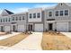 Street view of stylish townhomes, each with a one-car garage and tastefully landscaped front yards at 111 Central Townes Way # 299, Raleigh, NC 27603
