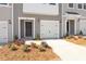 Beautiful townhome featuring a one-car garage, a tidy front lawn, and classic exterior lighting at 111 Central Townes Way # 299, Raleigh, NC 27603