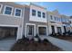 Charming townhome with a two-car garage and beautifully manicured front yard at 111 Central Townes Way # 299, Raleigh, NC 27603