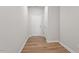 Neutral hallway featuring luxury vinyl plank flooring, a white door and baseboards and natural light at 111 Central Townes Way # 299, Raleigh, NC 27603