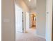 Carpeted hallway leading to bedrooms and bathrooms at 111 Central Townes Way # 299, Raleigh, NC 27603