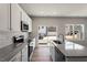Modern kitchen features granite counters, stainless appliances, and access to the outdoor area at 111 Central Townes Way # 299, Raleigh, NC 27603