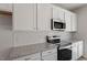 Close up of the kitchen featuring stainless steel appliances, granite counters, and white cabinets at 111 Central Townes Way # 299, Raleigh, NC 27603