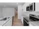 Contemporary kitchen with stainless steel appliances, granite countertops, and ample storage space at 111 Central Townes Way # 299, Raleigh, NC 27603