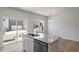 Kitchen island featuring stainless steel dishwasher, gray granite counters, and modern finishes at 111 Central Townes Way # 299, Raleigh, NC 27603