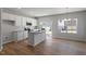 Bright kitchen featuring granite countertops, an island, stainless steel appliances and white cabinetry at 111 Central Townes Way # 299, Raleigh, NC 27603