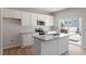 Modern kitchen with granite countertops, white cabinetry, stainless steel appliances and a sliding glass door at 111 Central Townes Way # 299, Raleigh, NC 27603