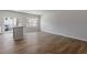Open floorplan featuring island with stainless steel dishwasher, hardwood floors, and neutral paint at 111 Central Townes Way # 299, Raleigh, NC 27603