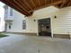 Backyard with large concrete patio and door leading into finished basement at 112 Gingergate Dr, Cary, NC 27519