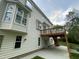 Exterior shot of home featuring a wooden deck with stairs and a covered patio space below at 112 Gingergate Dr, Cary, NC 27519