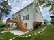 Expansive backyard featuring a multi-level deck, patio, and lush green lawn with beautiful gardens at 112 Gingergate Dr, Cary, NC 27519