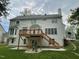Exterior shot of the home showing a spacious backyard with a wooden deck, stairs, and lush lawn at 112 Gingergate Dr, Cary, NC 27519