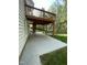Backyard with concrete patio and wooden deck that overlooks the yard at 112 Gingergate Dr, Cary, NC 27519