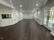 Walkout finished basement with modern lighting and convenient access to the outdoors at 112 Gingergate Dr, Cary, NC 27519