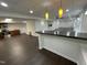 Finished basement with kitchen, bar and large living space with dark hardwood floors at 112 Gingergate Dr, Cary, NC 27519