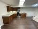 Basement kitchenette including stainless steel oven and microwave and granite countertops at 112 Gingergate Dr, Cary, NC 27519