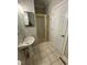 Bathroom featuring a stand-up shower with gold trim and a pedestal sink at 112 Gingergate Dr, Cary, NC 27519