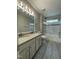 Bathroom with double sinks, tile floors, shower with black trim, and a toilet at 112 Gingergate Dr, Cary, NC 27519