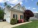 Brick and siding exterior with attached garage, walkway, and mature landscaping at 112 Gingergate Dr, Cary, NC 27519