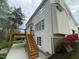 Back of house showing a deck and walk-out basement, with stairs going from the ground to the deck at 112 Gingergate Dr, Cary, NC 27519