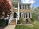 Beautiful home exterior with a well-maintained lawn, garden beds, and an inviting entrance at 112 Gingergate Dr, Cary, NC 27519