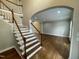 Inviting foyer with hardwood floors, staircase, and arched entryway to living area at 112 Gingergate Dr, Cary, NC 27519