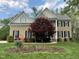 Charming brick home featuring a well-manicured lawn and colorful landscaping at 112 Gingergate Dr, Cary, NC 27519