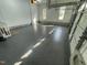 Epoxy-coated garage with bright lighting and high ceiling at 112 Gingergate Dr, Cary, NC 27519