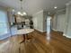 Open-concept kitchen with granite countertops, stainless steel appliances, and hardwood floors at 112 Gingergate Dr, Cary, NC 27519